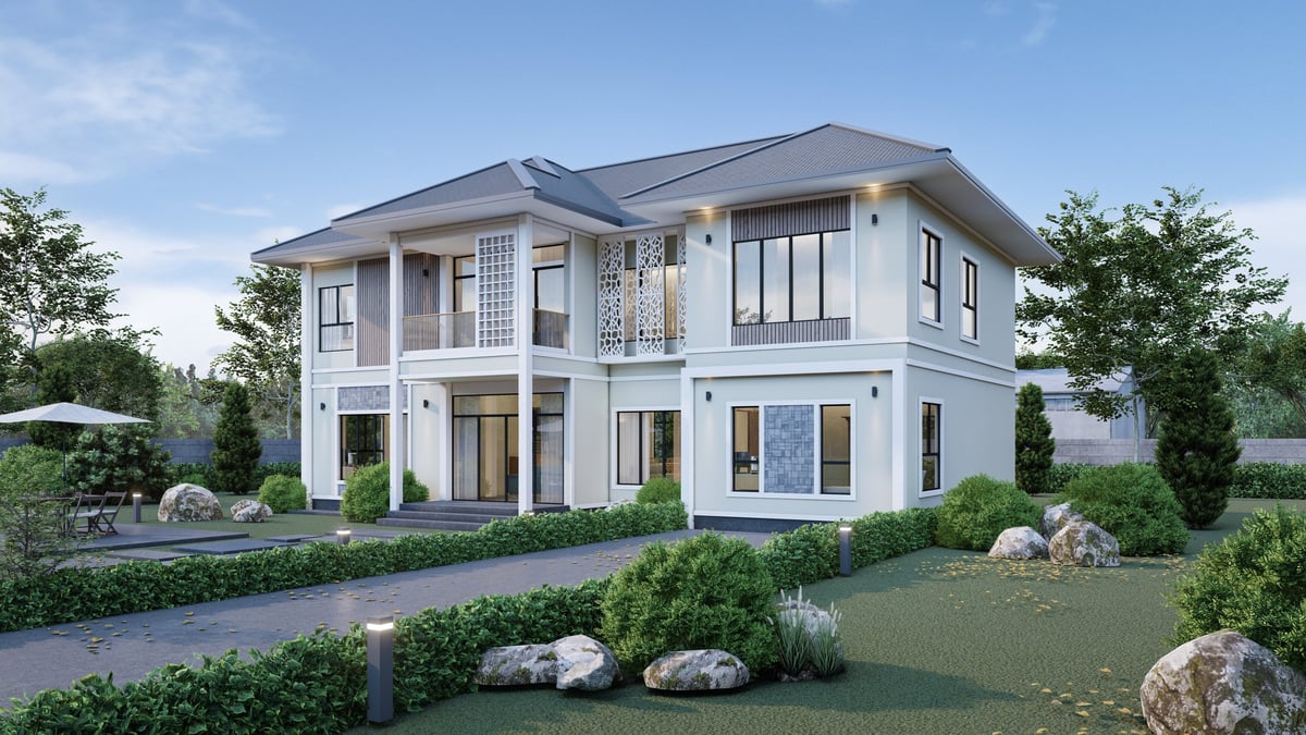 Modern two-story house with lush garden and driveway, representing a Serene Creations building project